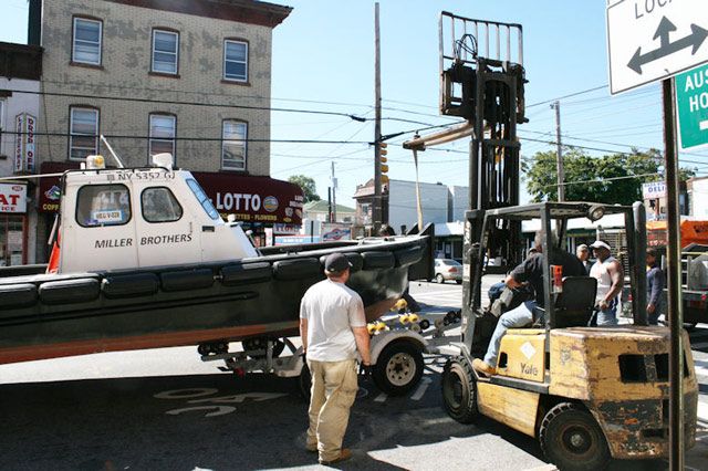 The boat being lifted back onto the trailer.